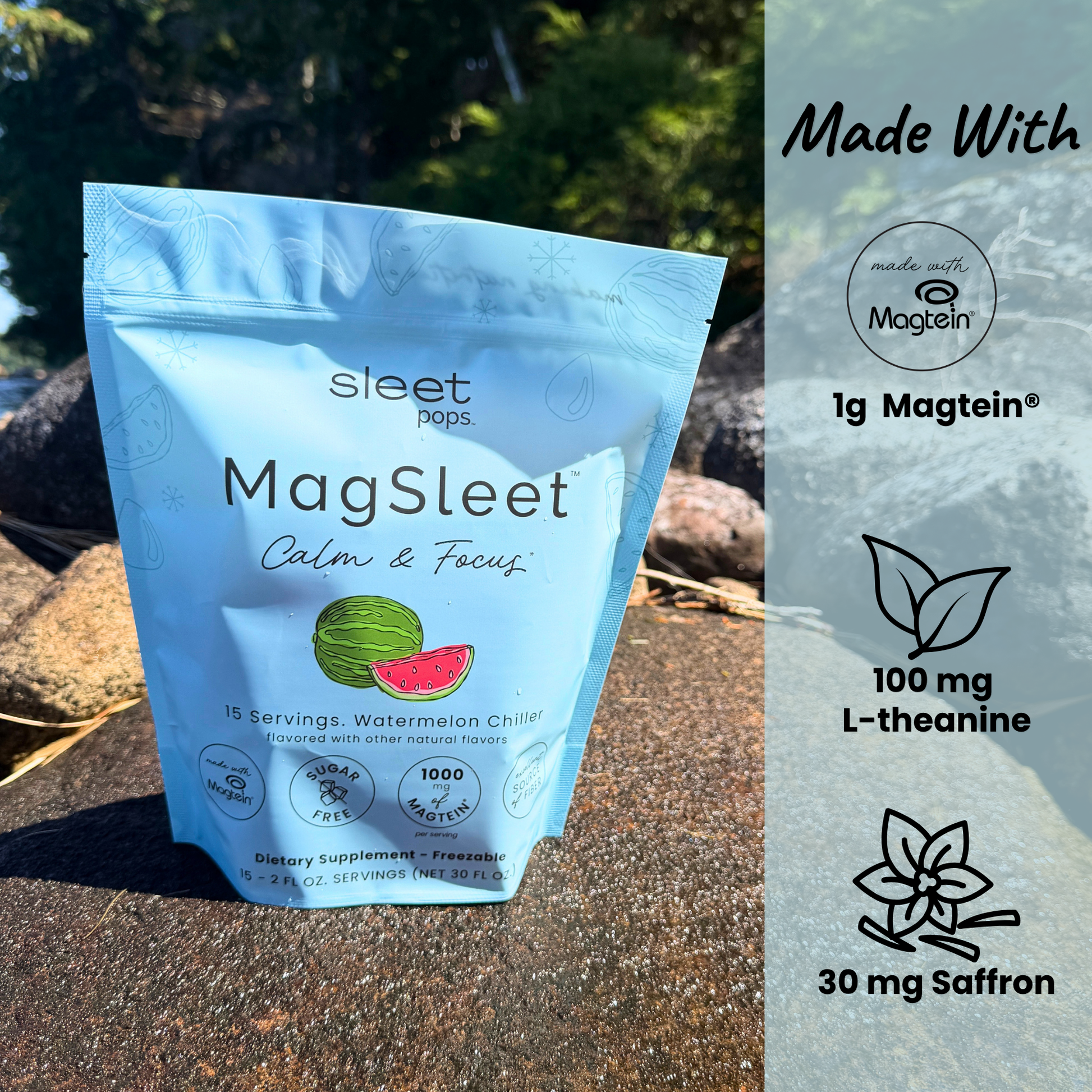 A stand-up pouch of Sleet Pops MagSleet dietary supplement placed outdoors on a stone surface with a blurred natural background. The package is light blue with a watermelon graphic and text reading 'Calm & Focus. Includes Made with Magtein, made with L-theanine and Saffron.   