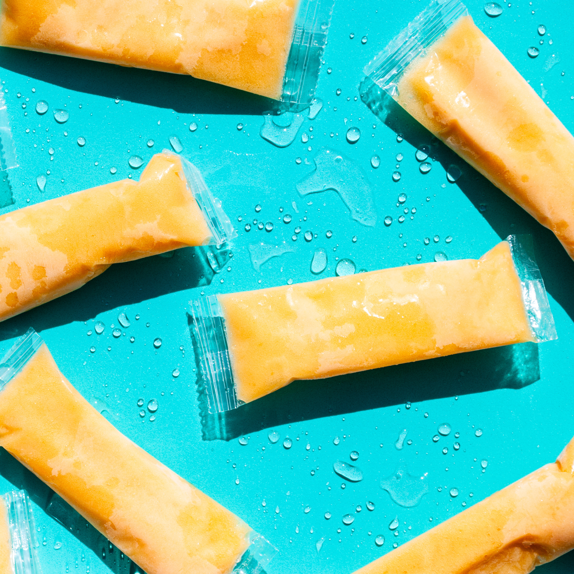Orange Sleet Pops on Teal Background 